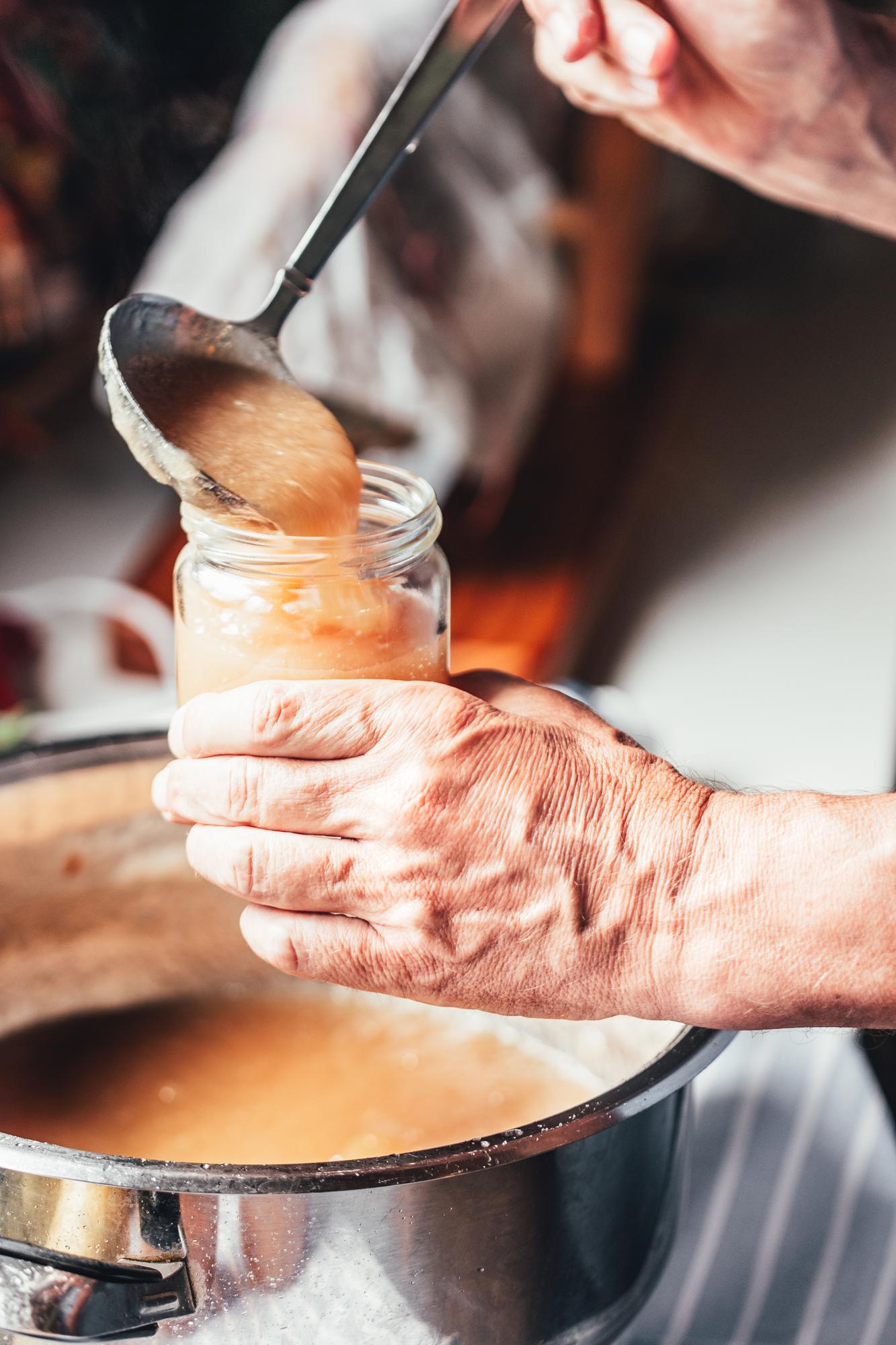 Hands finishing a sauce on a pan